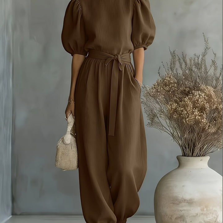 Bohemian-style Puff Sleeve Jumpsuit with Tie-waist. Features Side Pockets for Convenience, a Fit, and Comfortable Casual Wear